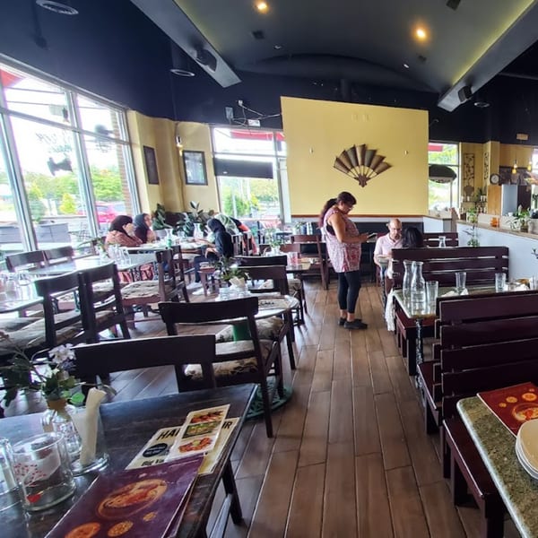 Interior of Dakshin Indian Bistro with patrons dining at tables and booths.